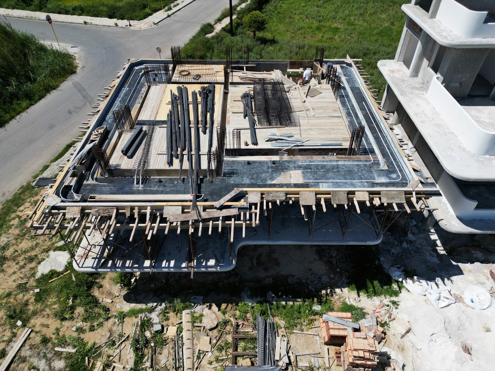Horizontal concrete bands forming terraces and shaded thresholds